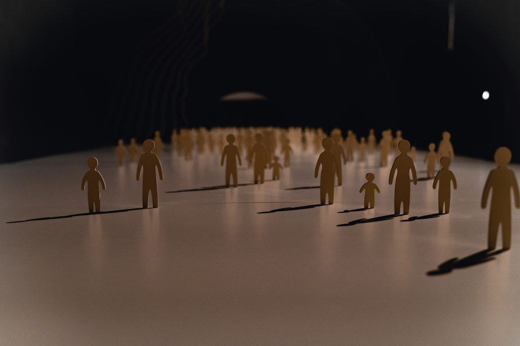 Silhouettes of paper people figures representing the family of God in church community.