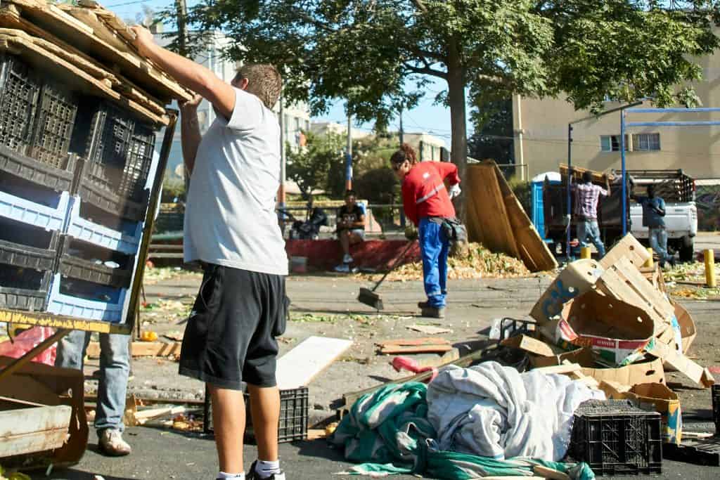 Efforts to beautify community spaces with volunteers cleaning and organizing outdoors.