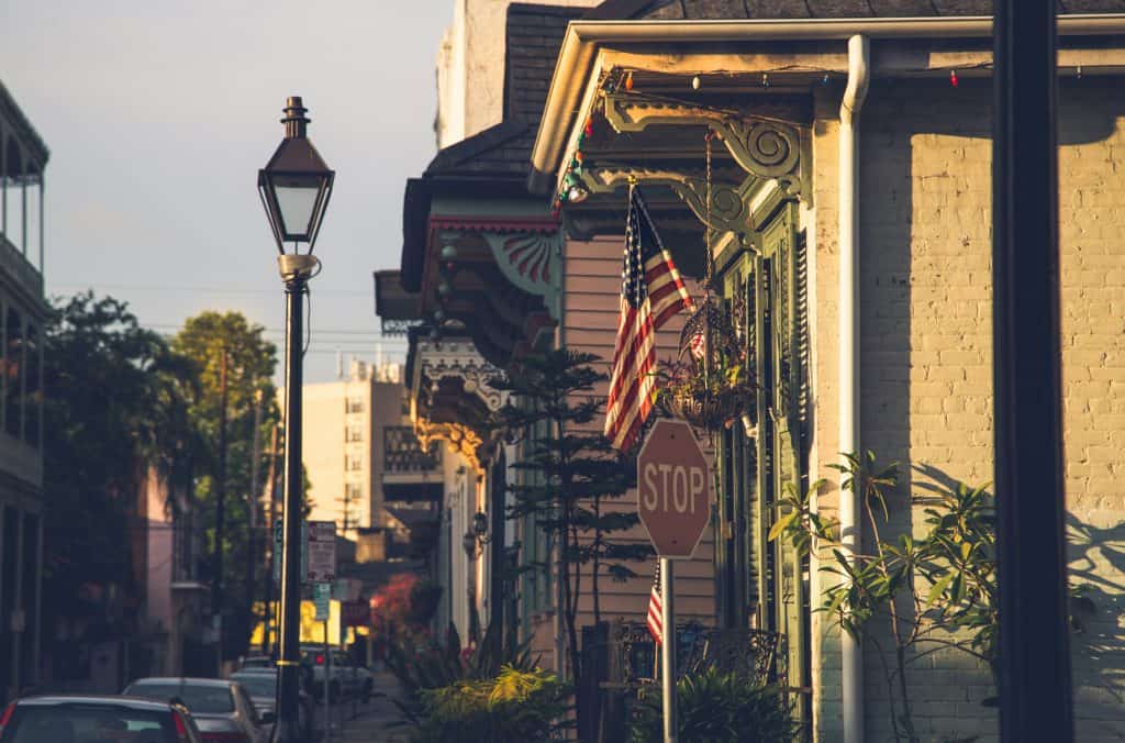 Historic church building with American flag and stop sign in a charming neighborhood.