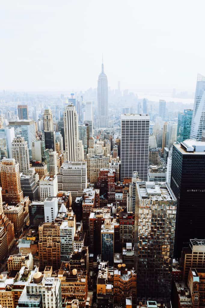 Empire State Building and NYC skyline with skyscrapers and urban landscape.