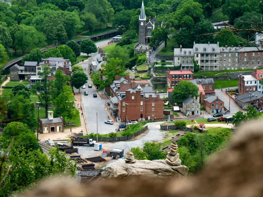 Church of Christ church with tall steeple in a picturesque town surrounded by lush greenery.
